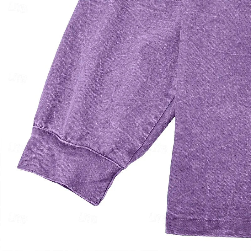 Close-up of the ribbed cuff and raglan sleeve seam on a purple washed henley shirt