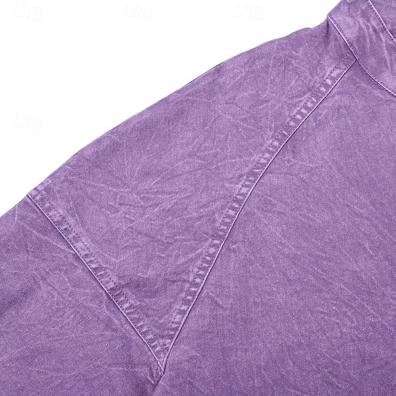 Detail shot of the raglan shoulder seam and stitching on a purple washed henley shirt