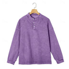 Front view of a purple washed henley shirt displayed on a wooden hanger