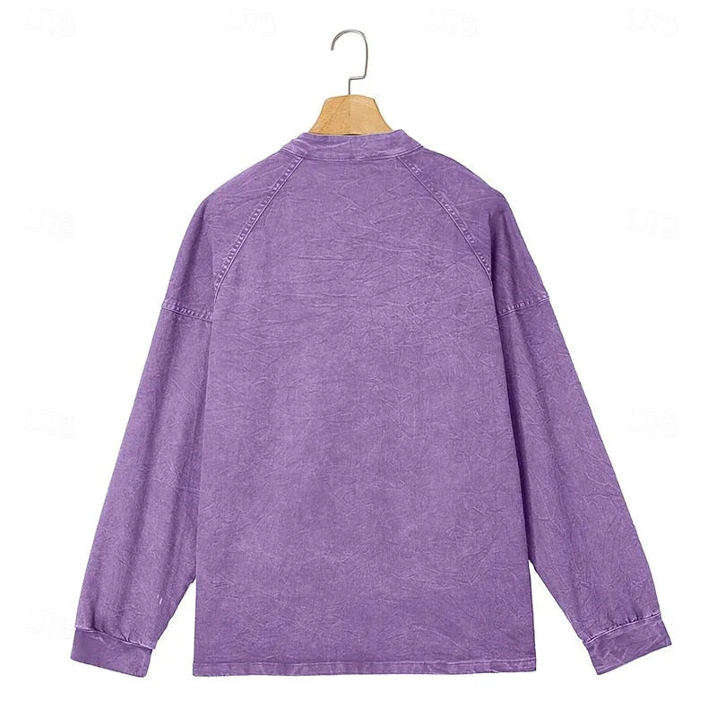 Back view of a purple washed henley shirt displayed on a wooden hanger showing raglan sleeves