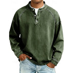 Front view of a man wearing a dark green washed henley shirt with standing collar and button placket
