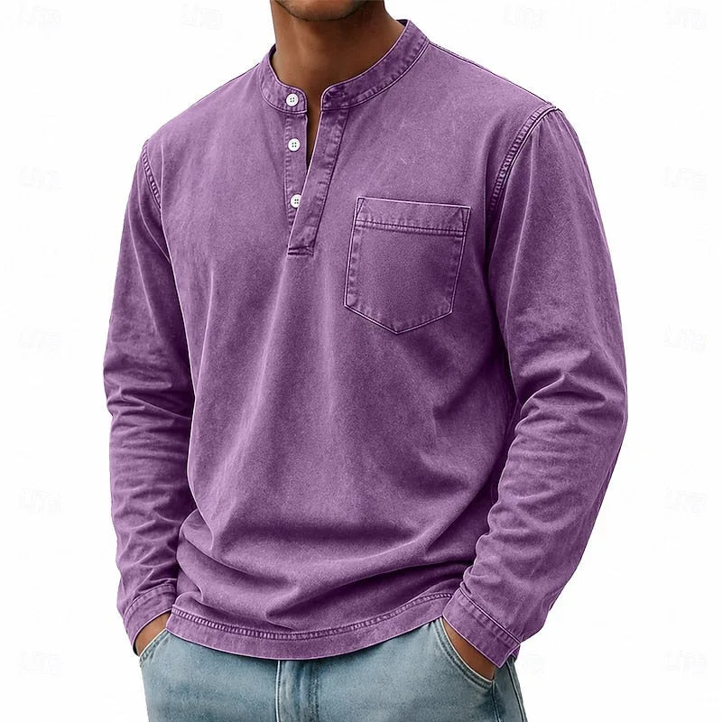 Man wearing a purple washed henley shirt with buttoned placket and chest pocket, front angled view