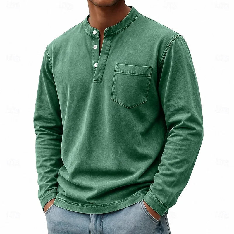 Man modelling a green washed henley shirt with visible chest pocket and stitched seams