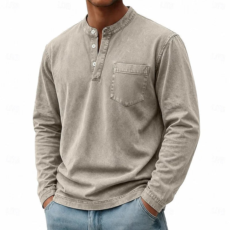 Front angled view of a grey washed henley shirt worn with light blue jeans