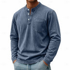 Man modelling a navy blue washed henley shirt with long sleeves and stand collar
