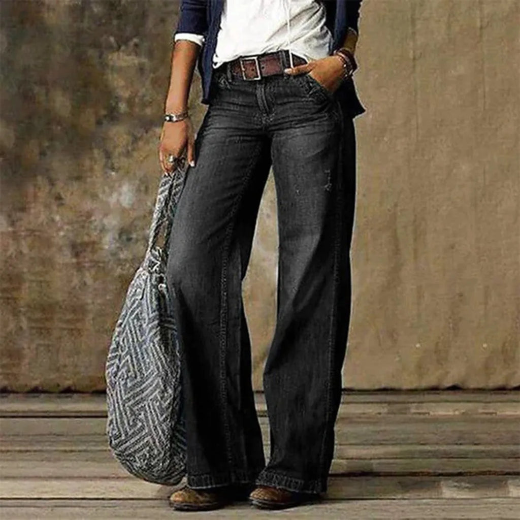 Black wash wide-leg denim jeans paired with brown ankle boots and a white top