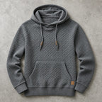 Dark grey waffle-knit hoodie with kangaroo pocket, ribbed cuffs and hem, and leather logo patch