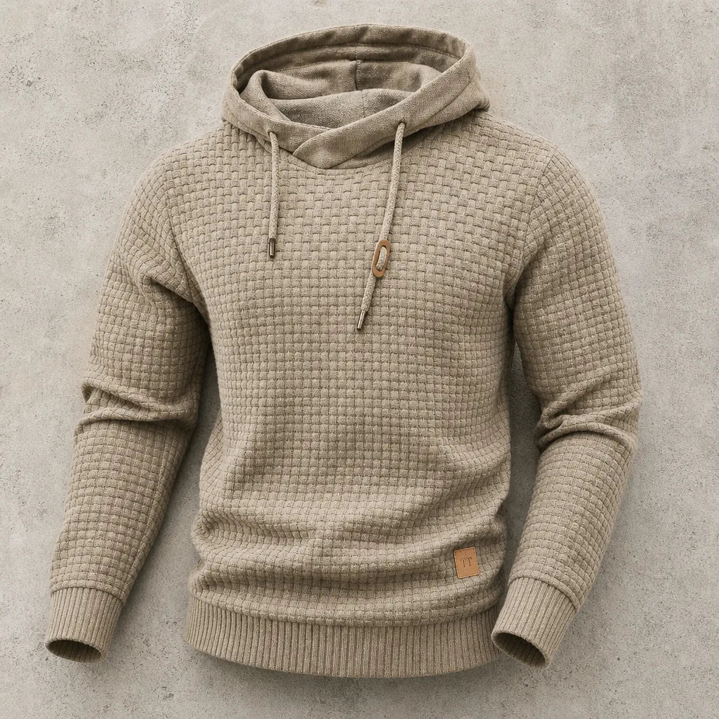 Khaki beige waffle-knit hoodie laid flat, highlighting cowl funnel neck and chunky basket-weave texture