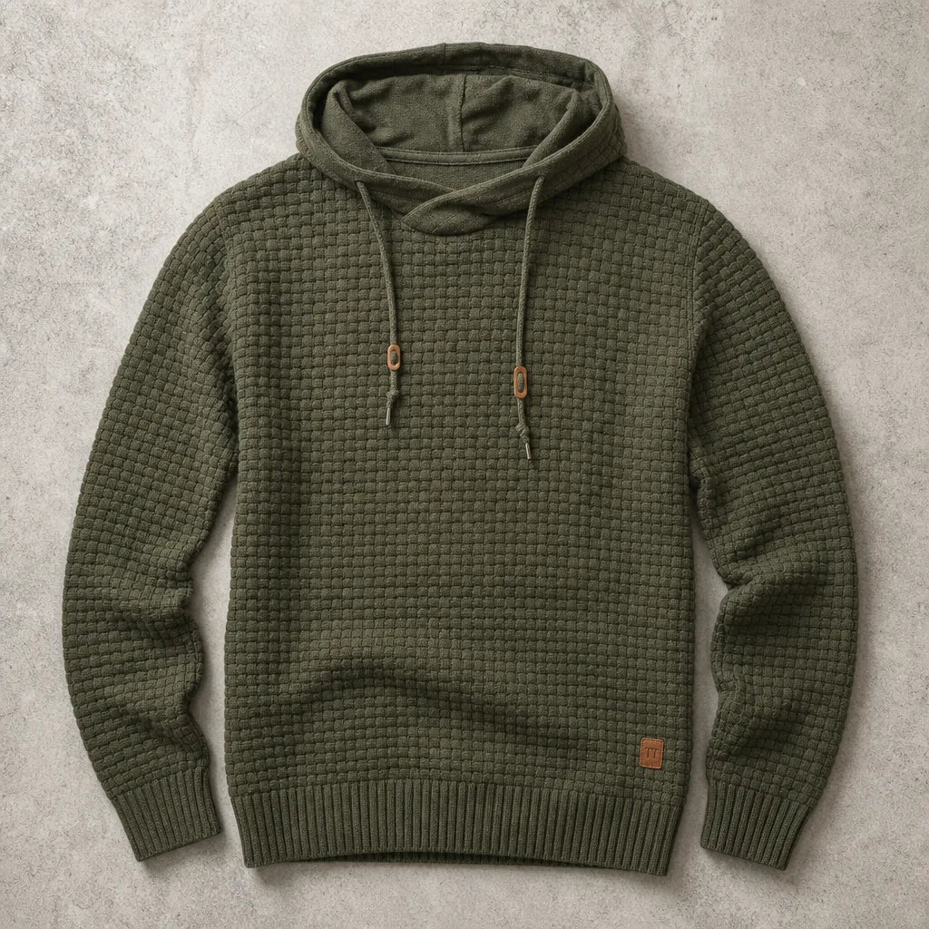 Army green waffle-knit pullover hoodie with cowl neck, drawstrings and ribbed cuffs on a stone backdrop