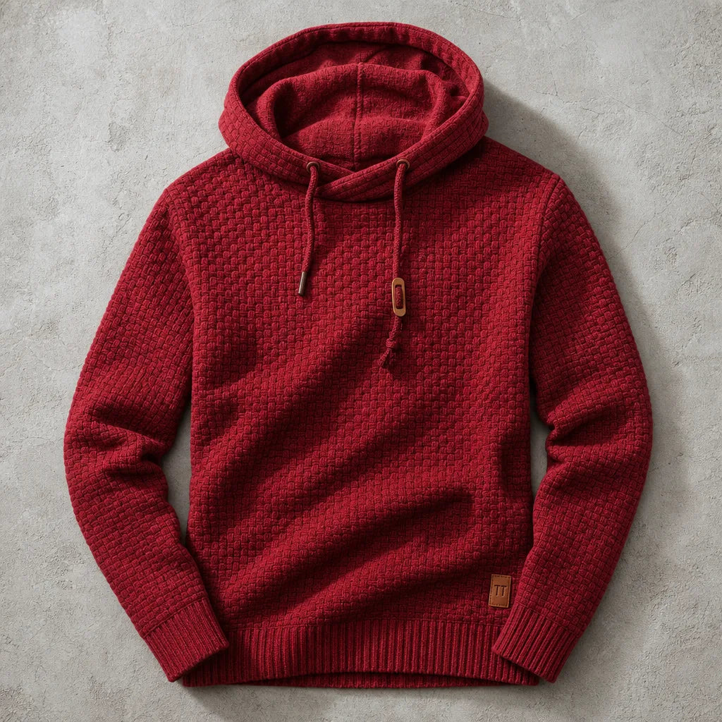 Red waffle-knit cowl-neck hoodie laid flat, showing ribbed hem and leather brand patch detail
