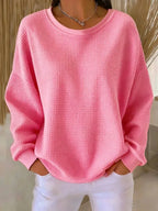 Front view of a red waffle-knit jumper highlighting the oversized dropped-shoulder silhouette