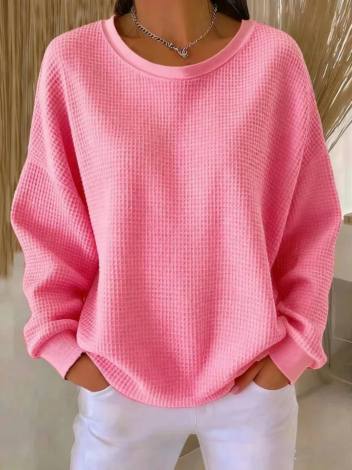 Front view of a red waffle-knit jumper highlighting the oversized dropped-shoulder silhouette