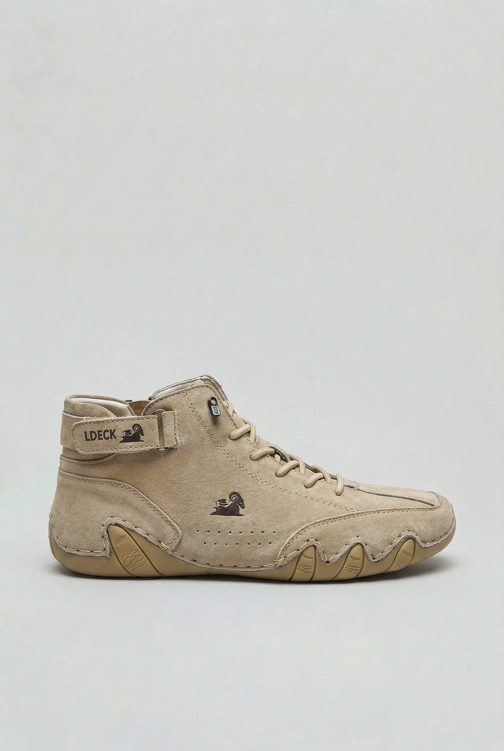Side profile of a beige suede high-top trainer boot with lace-up front and ridged tan outsole