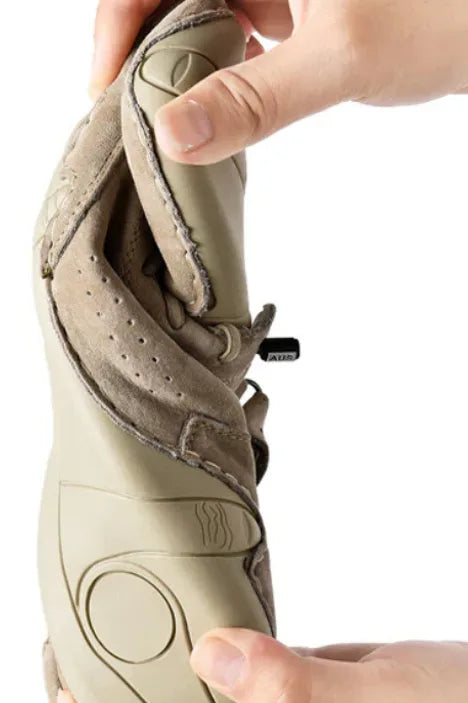 Close-up of hand pulling back the padded ankle collar to show the soft suede lining and side zip
