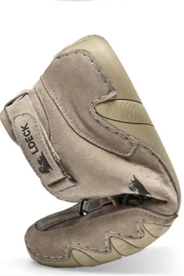 Angled rear view of a beige suede boot showing the heel pull tab, zip closure and chunky sole