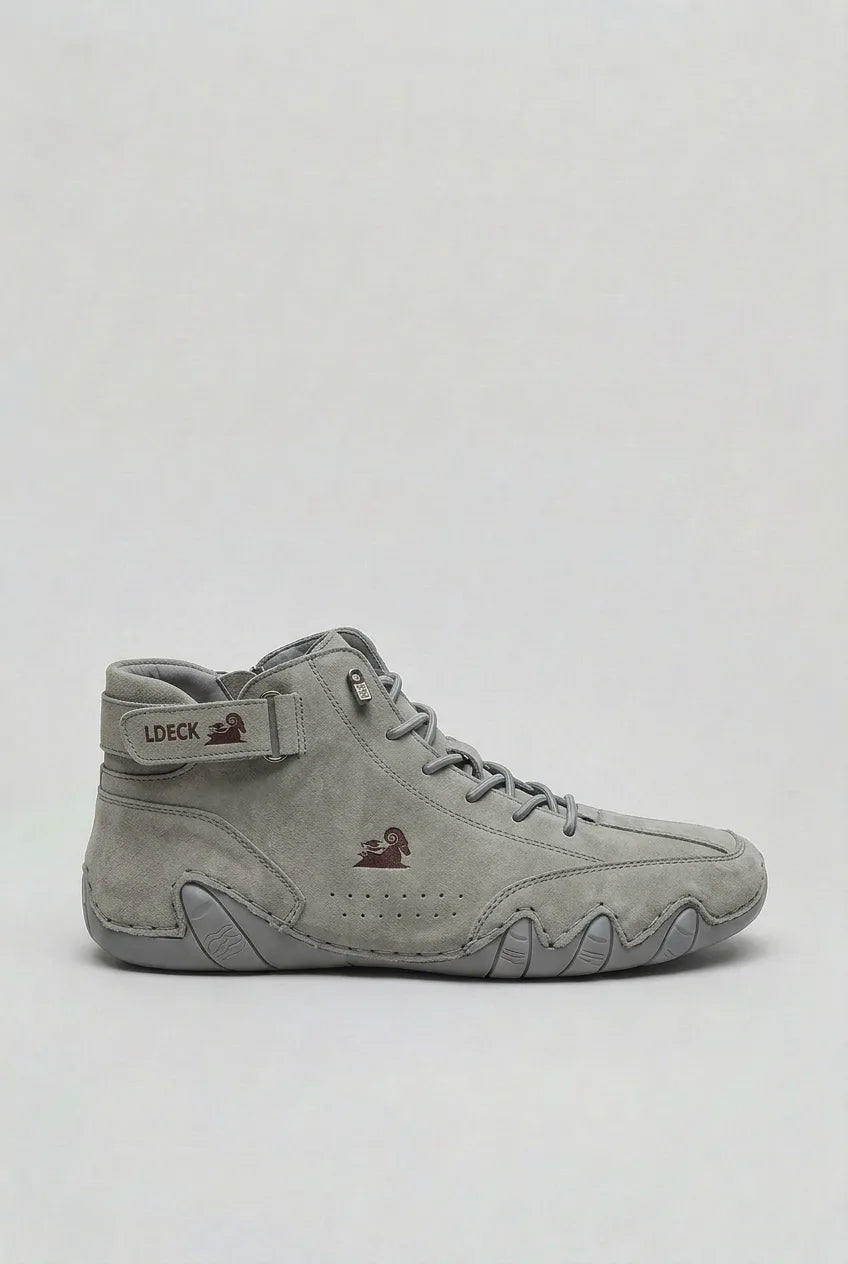 Side view of the same boot style in light grey suede with a burgundy ram logo on the tongue