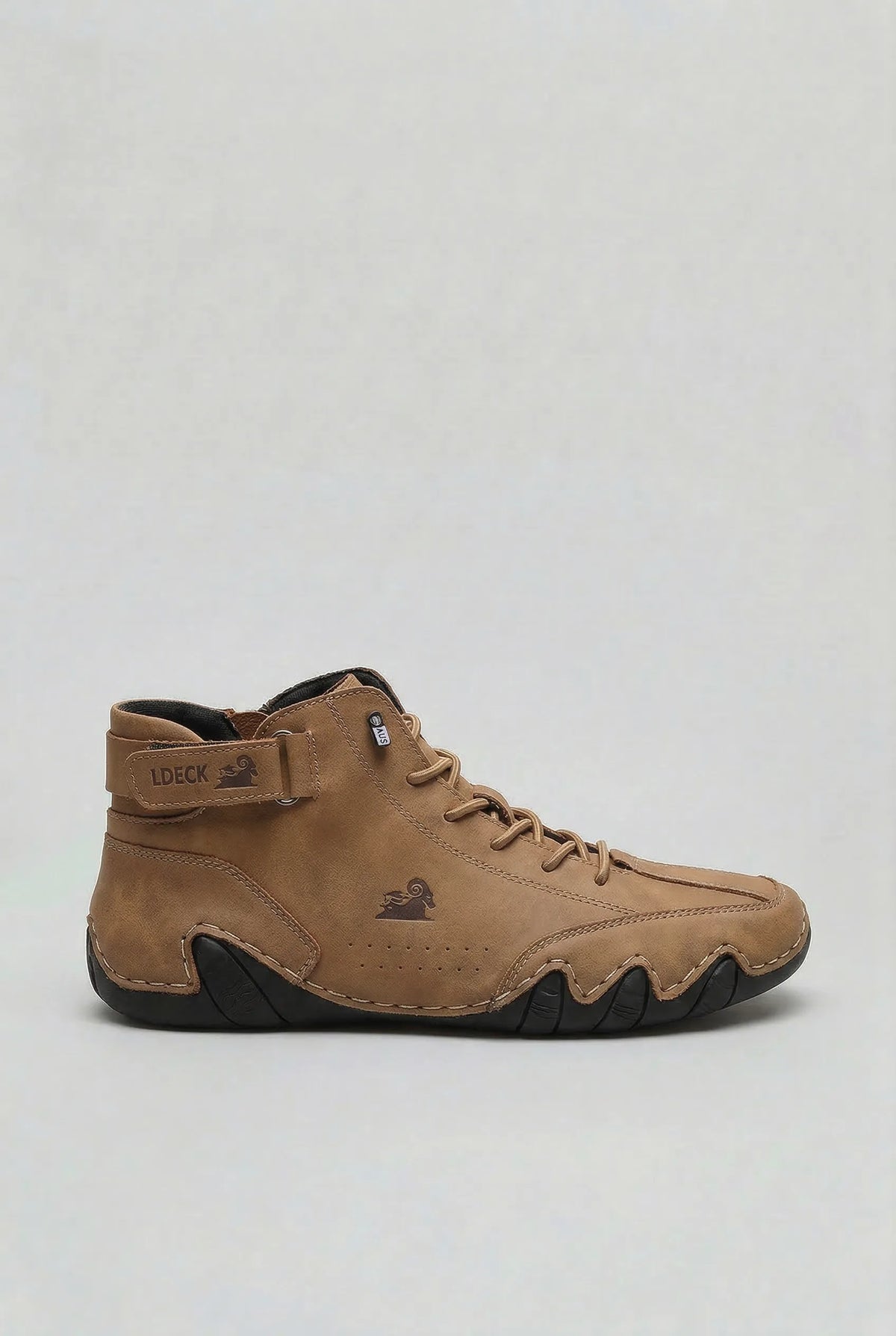 Side view of the boot in tan nubuck leather with a contrasting black ridged outsole