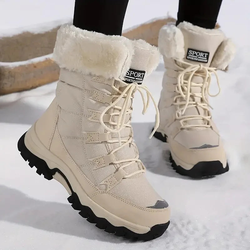 Beige waterproof winter boot with plush faux-fur cuff, lace-up front and chunky black sole, shown walking on snow.