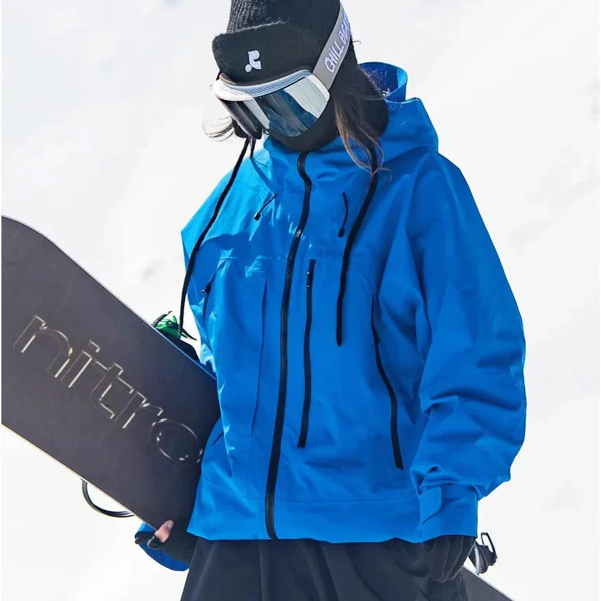Front view of a vivid blue waterproof ski jacket with full-length zip and toggle drawstrings, worn while holding a snowboard