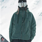Model wearing a forest green hooded ski jacket with contrast black zips and drawcords against a snowy backdrop