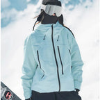 Rear three-quarter view of the pale blue jacket showing the hood drawstrings and relaxed oversized fit