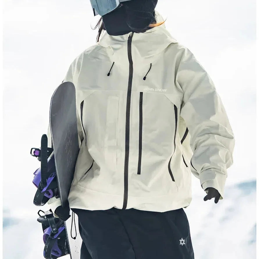 Back view of the off-white ski jacket paired with black trousers, snowboard held under one arm