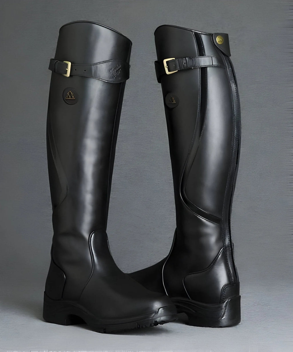 Pair of glossy black leather knee-high boots with buckle straps and branded heel patch, studio shot