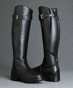 Pair of glossy black leather knee-high boots with buckle straps and branded heel patch, studio shot