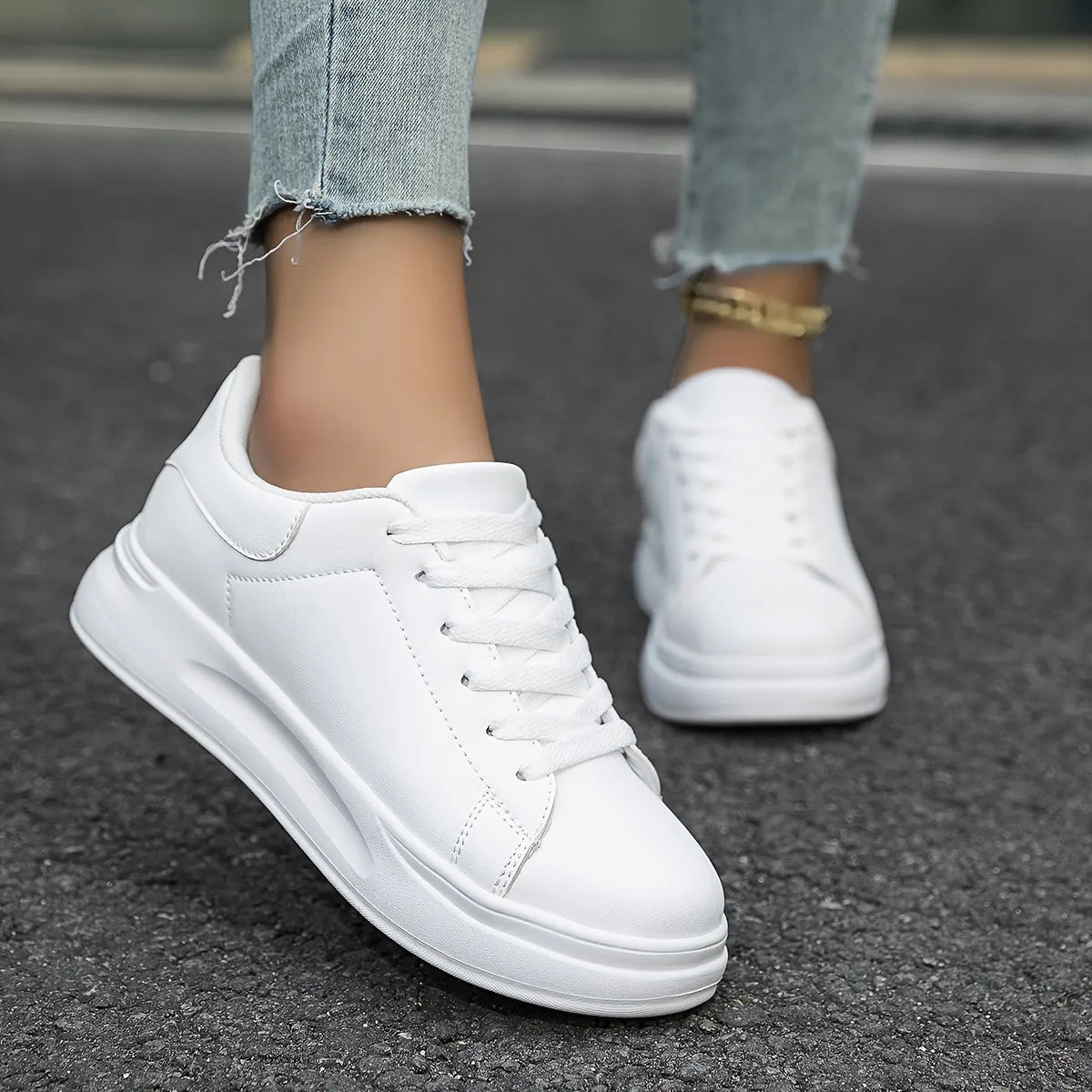 Side profile of all-white leather trainer without contrast panel, showing clean minimalist upper