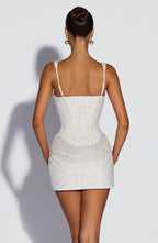 Back view showing the lace-up corset detail and adjustable straps on the sequin mini dress