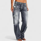 Front view of grey distressed jeans with a faded wash and frayed rip detailing on the leg.