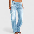 Side-angled view of light-blue distressed jeans showing the wide-leg silhouette and frayed hem.
