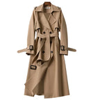 Khaki double-breasted trench coat with belted waist, epaulettes and storm flap, shown from the front