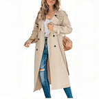 Front view of a khaki double-breasted trench coat with notched lapel and belted sleeves, worn open.