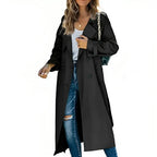 Black double-breasted trench coat with classic lapel and button placket, worn as an open outer layer.