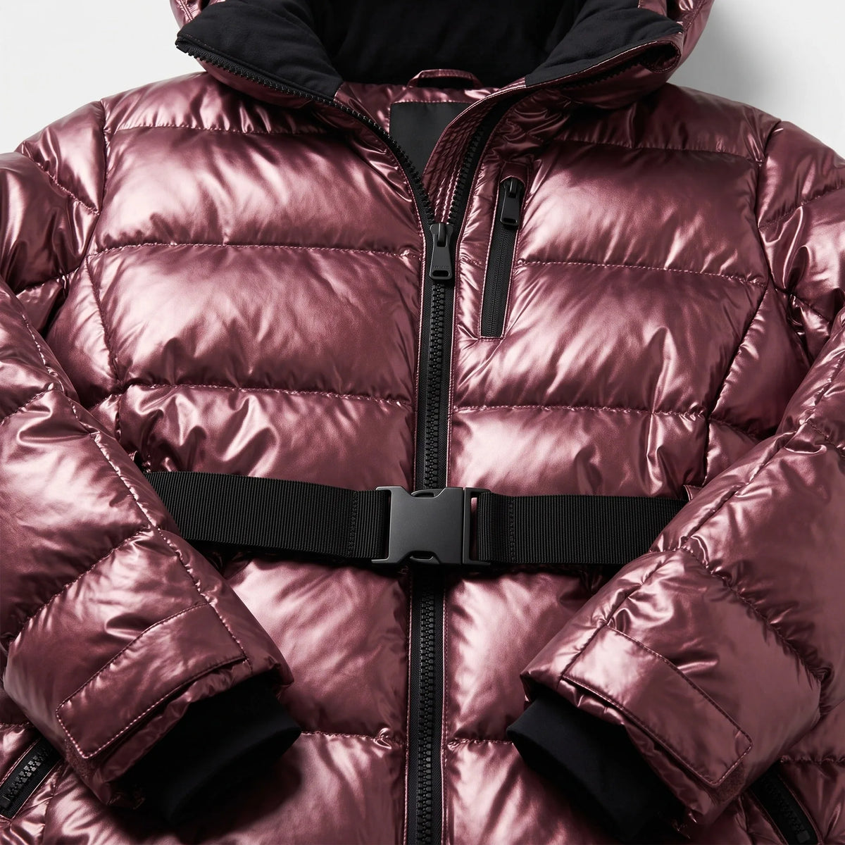 Close-up of the front zip, chest pocket and black buckle waist belt on the metallic burgundy puffer jacket