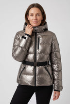 Woman wearing a metallic pewter hooded puffer jacket with touch-fasten cuff tab and belted waist