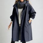 Navy hooded raincoat buttoned to the collar, front view showing full button placket and roomy sleeves