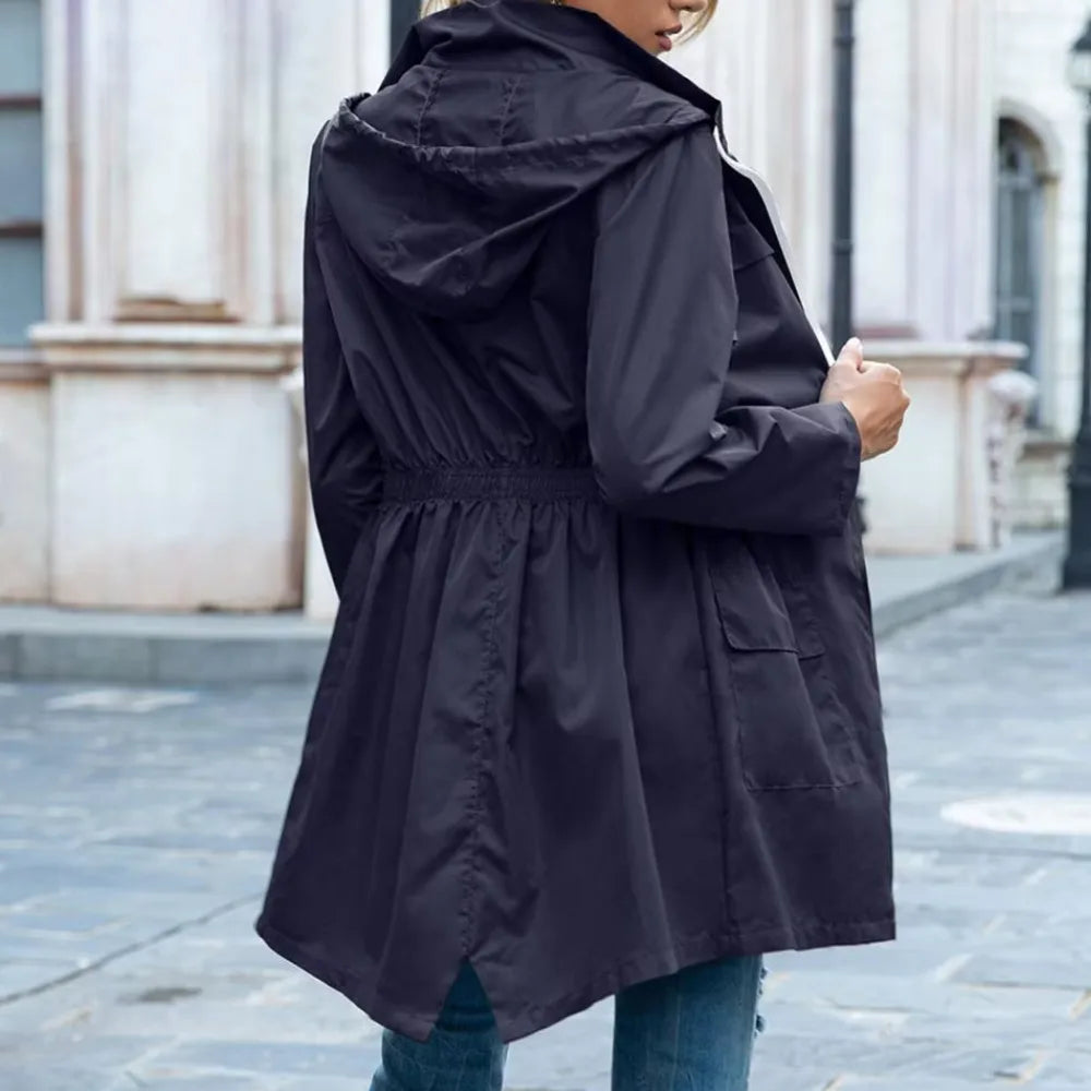 Back view of a black hooded trench coat showing the elasticated waist seam and relaxed, slightly longline cut