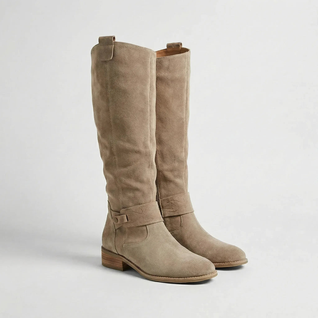 Pair of beige suede-look knee-high boots with relaxed slouch silhouette and low heel, close side view