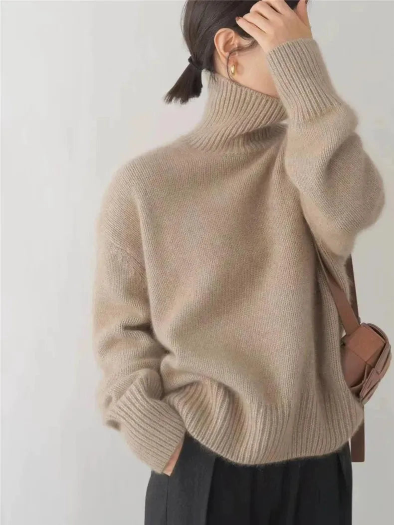 Back and side view of a taupe polo neck jumper with dropped shoulders and a brown crossbody bag