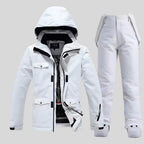 Women's white ski jacket and matching white trousers, front view with hood up and jacket unzipped showing patterned lining