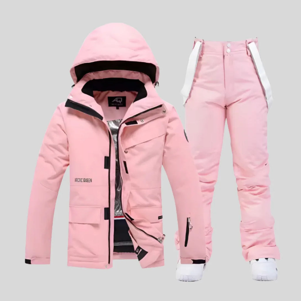 Full front view of the matching ski jacket and trousers set styled with trainers