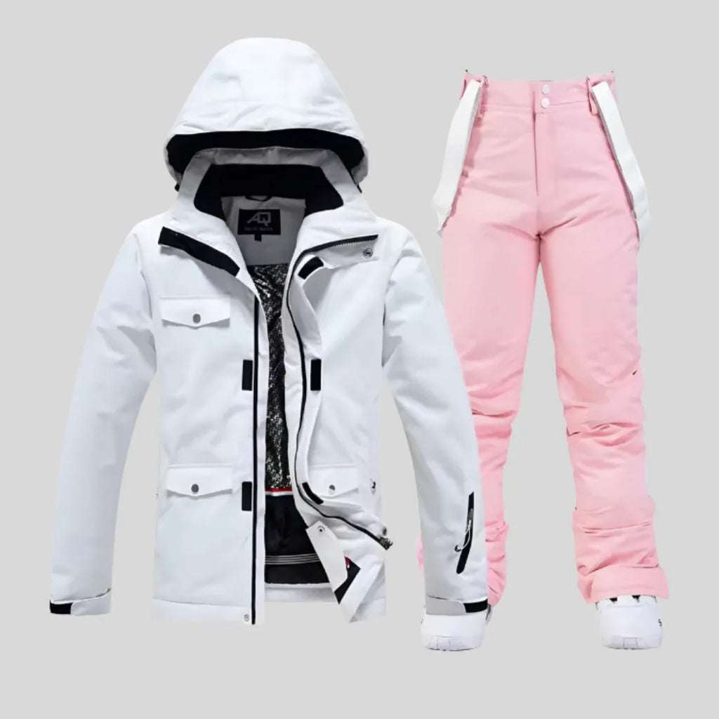 White ski jacket paired with soft pink bib trousers featuring adjustable shoulder straps