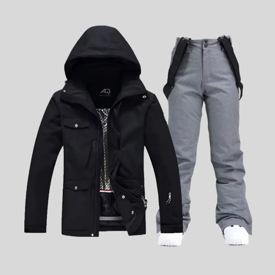 Pink hooded ski jacket paired with white bib trousers and white trainers, front view