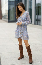 Front angled view of tan suede knee-high boots highlighting the low block heel and slouch shaft