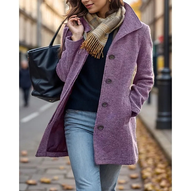 Woman in mauve purple wool-blend coat with turndown collar and button-front, carrying a black tote bag on a city street