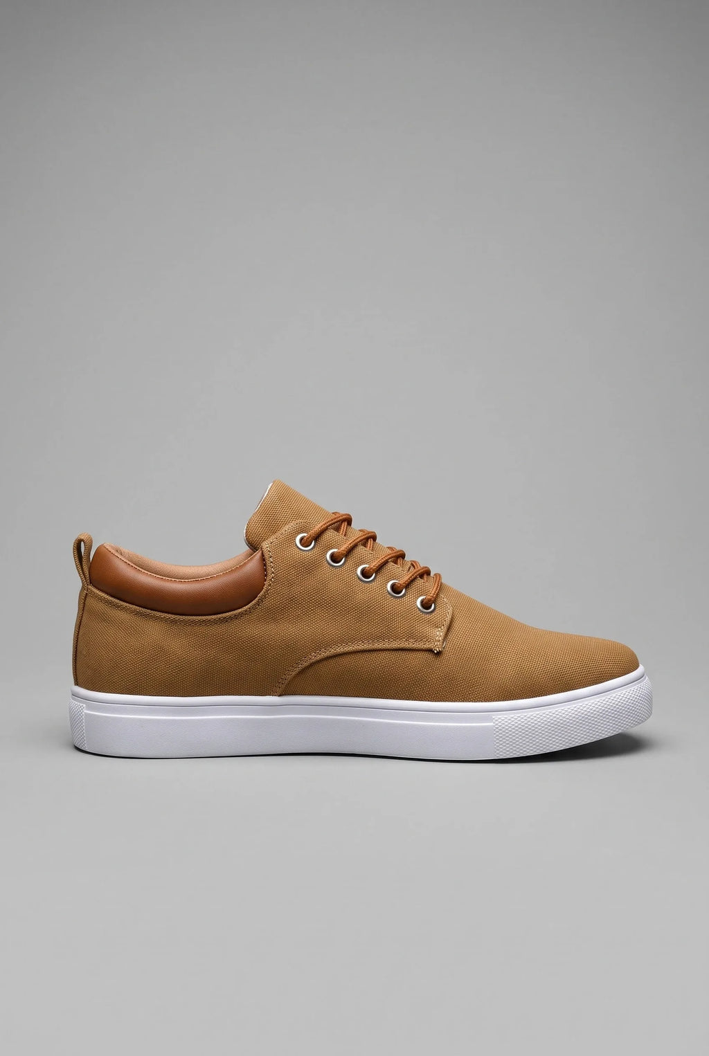 Side view of tan canvas trainer with woven textile upper, tan leather heel tab and white cupsole