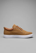 Side view of tan canvas trainer with woven textile upper, tan leather heel tab and white cupsole