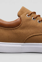 Close-up of tan woven upper showing lace eyelets, tan laces and contrast leather heel detail